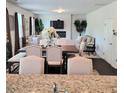 Elegant dining room with fireplace, featuring a large table, stylish chairs, and ample seating for entertaining guests at 110 Halibut Cir, Covington, GA 30016