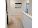 Bright hallway featuring neutral carpeting, white walls, and a simple mirror, enhancing the home's spacious feel at 110 Halibut Cir, Covington, GA 30016