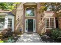 Welcoming front entrance featuring a black front door, sidelights, transom window, and brick facade at 1235 Legend Run, Alpharetta, GA 30005