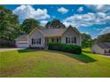 Charming single-Gathering home featuring well-maintained landscaping and classic architectural details at 65 Ashland Farm Rd, Oxford, GA 30054