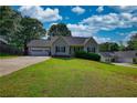 Lovely single-Gathering home with a two-car garage and a lush green lawn at 65 Ashland Farm Rd, Oxford, GA 30054