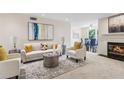 Elegant living room with fireplace, comfortable seating, and open view to the dining area at 66 Devon Ln, Avondale Estates, GA 30002