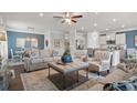Bright living space with plush seating, a ceiling fan, and an open layout connecting the kitchen and dining area at 1315 Elowen Dr, Austell, GA 30168