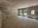 Open concept living room with a door to outside and large windows, with neutral tones at 2076 Boxwood Circle Se, Conyers, GA 30094