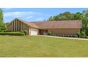 Ranch-style home boasting an attached garage, a pristine lawn, and sculpted shrubbery lining the walkway at 1724 Arbor Hill Rd, Canton, GA 30115