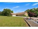 Well-maintained home with a large, green yard, a circular driveway, and meticulous landscaping along the foundation at 1724 Arbor Hill Rd, Canton, GA 30115
