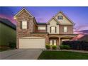 Charming two-story home with brick accents, well-kept lawn, and a two-car garage at 3755 Lake Haven Way, Atlanta, GA 30349