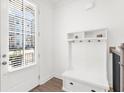 Bright entryway featuring a built-in coat rack and storage bench at 3239 Bartee Walk, Suwanee, GA 30024