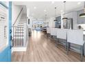 Open-concept kitchen with sleek countertops, stainless steel appliances, and island seating at 3239 Bartee Walk, Suwanee, GA 30024