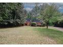 Beautiful brick home with an expansive green lawn and mature trees at 110 Vistacrest Way, Roswell, GA 30075