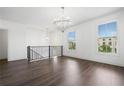 Bright and spacious loft area with hardwood floors, chandelier, and large windows overlooking the neighborhood at 244 Church St, Lawrenceville, GA 30046