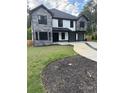 Beautiful home featuring stone and white siding, black window trim, and a three-car garage at 2740 Drew Valley Ne Rd, Brookhaven, GA 30319