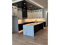 Stylish kitchen featuring a large island with a waterfall countertop, black hardware, and custom cabinetry at 2740 Drew Valley Ne Rd, Brookhaven, GA 30319