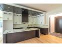 Spacious kitchen featuring white cabinets, dark countertops, a large island with a marble top, and modern appliances at 2740 Drew Valley Ne Rd, Brookhaven, GA 30319