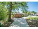 Brick house exterior with driveway and tree at 3710 A B Lynn Dr, Powder Springs, GA 30127