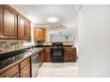 Well-maintained kitchen featuring stone backsplash, stainless steel dishwasher, and dark countertops at 7248 Banks Mill Rd, Douglasville, GA 30135