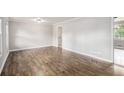 Spacious living room showcasing beautiful hardwood floors, light gray walls, and neutral trim throughout at 7248 Banks Mill Rd, Douglasville, GA 30135