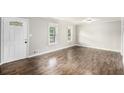 Inviting living room with hardwood floors, updated paint, and natural light from the white-trimmed windows at 7248 Banks Mill Rd, Douglasville, GA 30135