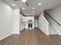 Inviting living area with hard surface flooring, a ceiling fan, and an open-concept kitchen at 18 Black Gum Ln # 53, Auburn, GA 30011
