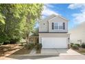 Beautiful two-story home with a front yard, two-car garage and a driveway on a sunny day at 606 Windcroft Nw Cir, Acworth, GA 30101