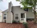 Exterior side view of the home showcasing vinyl siding, well-maintained landscaping and cozy front porch at 606 Windcroft Nw Cir, Acworth, GA 30101