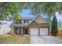 Traditional two-story home boasting a brick facade, shuttered windows, and a two-car garage at 7454 Silver Arrow Se Trl, Austell, GA 30168
