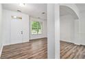 Inviting living area featuring hardwood floors, a large window, and neutral paint at 7454 Silver Arrow Se Trl, Austell, GA 30168