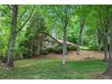 Well-maintained single-story home with mature trees, landscaping, and a lush lawn at 12080 Mountain Laurel Dr, Roswell, GA 30075