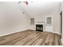 Bright living room featuring a fireplace, new floors and an exit door at 155 Oak Terrace Dr, Covington, GA 30016