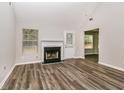 Bright living room featuring a fireplace, new floors and a high ceiling at 155 Oak Terrace Dr, Covington, GA 30016