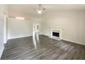 Open living room with hardwood floors, vaulted ceilings, a fireplace, and plenty of natural light at 2012 Elm Grove Ln, Hampton, GA 30228