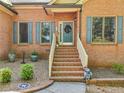 Charming brick home with steps up to the doorway with shutters and a landscaped front yard at 318 Dogwood Trce, Mcdonough, GA 30252