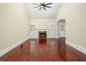 Bright living room with high ceilings, hardwood floors, a cozy fireplace, and large windows with shutter accents at 440 Hickory Glen Sw Ln, Atlanta, GA 30311