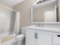 Clean bathroom features a shower-tub combo with tile surround and a white vanity with modern fixtures at 6292 Field Glen Rd, Stone Mountain, GA 30087