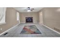 Spacious living room featuring tile flooring, a cozy fireplace, and abundant natural light at 2675 Paul Thomas Dr, Dacula, GA 30019