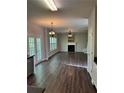 Open-concept living room with hardwood floors, fireplace, and access to a backyard patio at 3063 Grace Ct, Lawrenceville, GA 30043