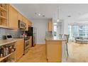 Open kitchen with stainless steel appliances, granite countertops, and hardwood floors at 325 E Paces Ferry Ne Rd # 602, Atlanta, GA 30305