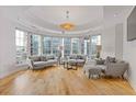Bright living room featuring hardwood floors, large windows, and modern decor at 325 E Paces Ferry Ne Rd # 602, Atlanta, GA 30305