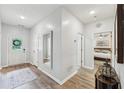 Inviting entryway with wood flooring, a decorative mirror, and a view of the bedroom at 409 Norton Xing, Woodstock, GA 30188