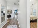 Bright hallway with wood floors, leading to the living area and bedrooms at 409 Norton Xing, Woodstock, GA 30188