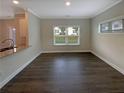 Dining area with hardwood flooring is well-lit with natural light from a large window at 7721 Fawn Cir, Covington, GA 30014