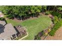 Sprawling backyard with lush green grass and mature trees at 1440 Water View Ln, Suwanee, GA 30024