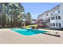 Backyard with a large in-ground pool, diving board, patio furniture, and a covered deck at 300 Bermuda Ct, Dallas, GA 30157