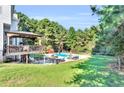 Outdoor entertainment area with an in-ground pool, open patio space, and covered deck at 300 Bermuda Ct, Dallas, GA 30157