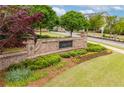 Attractive brick entrance with lush landscaping creates a welcoming gateway to the Harlow community at 10200 Windalier Way, Roswell, GA 30076