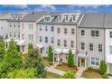 Stylish townhomes featuring painted brick, covered entrances, and beautiful landscaping at 10200 Windalier Way, Roswell, GA 30076
