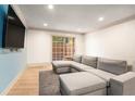 Bright living room featuring a comfortable gray sectional sofa and sliding door to the outside at 3135 Seven Pines Ct # 101, Atlanta, GA 30339