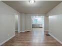 Open dining room with wood floors leading to a kitchen with stainless steel appliances at 3140 Delowe Dr, Atlanta, GA 30344