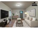 Cozy living room with hardwood floors, neutral colors, stylish furniture, and a modern entertainment center at 3140 Delowe Dr, Atlanta, GA 30344