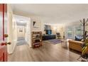 View of the open living room, featuring a brown leather couch, accent rug, and sliding glass doors to the outside at 3472 Essex Ave # 81, Atlanta, GA 30339